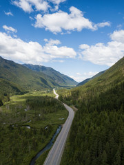 Aerial view of a scenic road going through the valley surrounded by the Beautiful Canadian Mountains. Located between Hope and Princeton, BC, Canada.