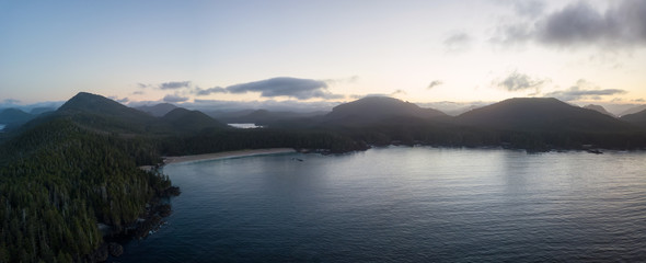 Beautiful aerial panoramic seascape view of Pacific Ocean Coast during a vibrant summer sunrise. Taken at Grant Bay, Northern Vancouver Island, BC, Canada.
