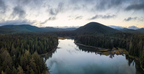 Striking aerial panoramic view of the river by Pacific Ocean Coast during a vibrant summer sunrise. Taken in San Josef Bay, Cape Scott, Northern Vancouver Island, BC, Canada.