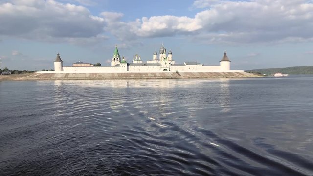 Macarius Monastery is a traditional Russian monastery on the Volga River. Reflection, ripples and boats waves 