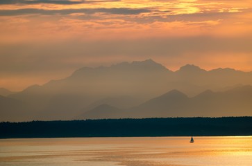 Lone Sailboat and the Olympic Mountains