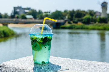 Mojito cocktail on a granite parapet with river on background
