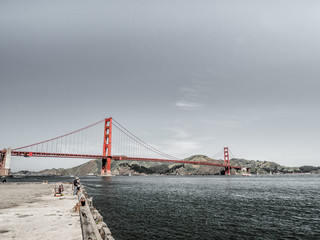 Beautiful photograph of the iconic Golden Gate Bridge in San Francisco with concrete and steel pier...