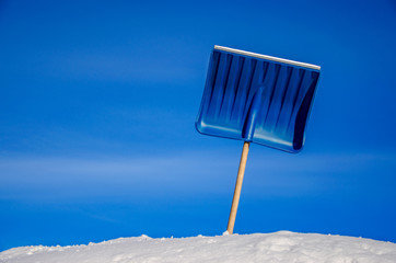 Shovel in the snow against the sky