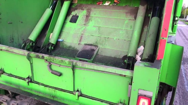 Garbage truck crushing rubbish.