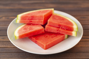 Red sliced watermelon on wooden table background