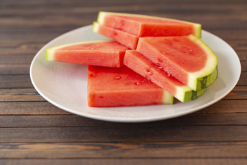 Red sliced watermelon on wooden table background