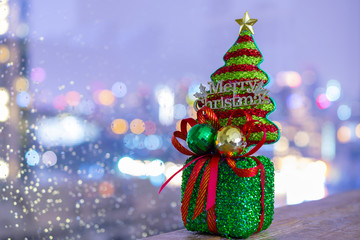 Christmas gift with beautiful bokeh city background for holiday celebration concept.