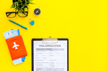 Planning a vacation, planning a trip. Visa application form near passport and airplane ticket on...