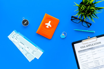 Preparing to travel. Legalize papers. Visa application form near passport and airplane ticket on...