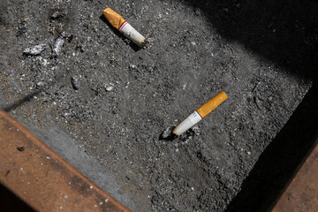 Many Cigarette butts in the dirty ashtray, Smoking is bad for your health.