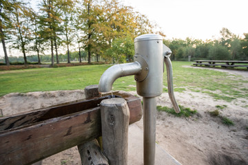 Fototapeta na wymiar a wooden waterfall with a water pump