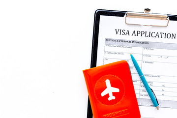 Visa processing, registration. Visa application form near passport cover with airplane on white background top view copy space