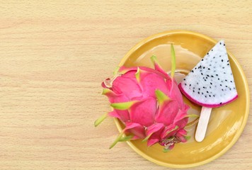 Dragon Fruit isolated on wooden background