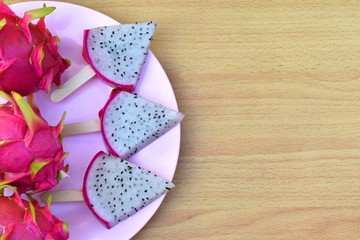 Dragon Fruit isolated on wooden background