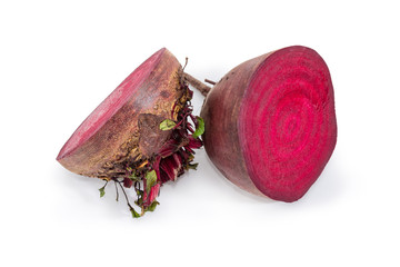 Uncooked red beetroot cut in half on a white background