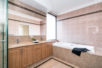 Large clean bathroom with bathtub and luxury fittings.