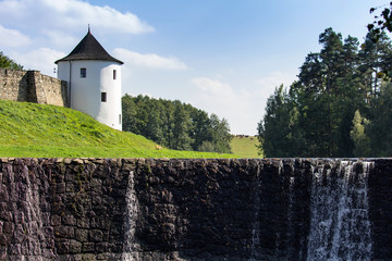 Small weir with Tower of old castle Zumberk, Czech republic