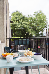 Light healthy Breakfast with oatmeal and coffee on a turquoise table. Hercules, nuts, fruit, boiled eggs, bread, coffee. Tableware. Healthy food. 