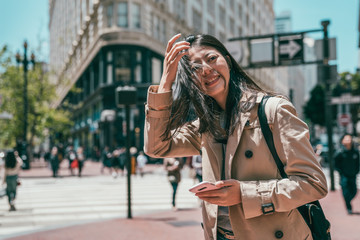 Fototapeta premium woman standing in street and looking happily