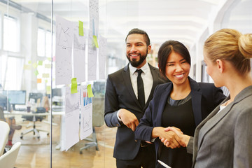 Businesswoman contratulates collegue success