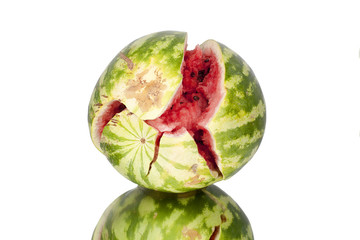 Chopped watermelon on white mirror background with reflection isolated close up