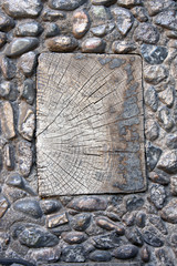 Fototapeta na wymiar Wooden plank in ancient paving stone