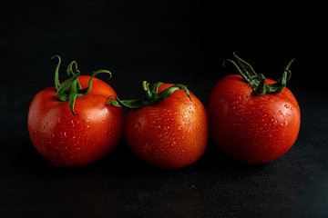 Tomatoes on black background