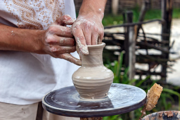 Human hands make a clay jug close-up. Sculptor's workshop. The sculptor makes a jug of clay close-up.