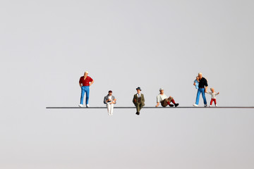 The miniature of various men on the cliff. - obrazy, fototapety, plakaty