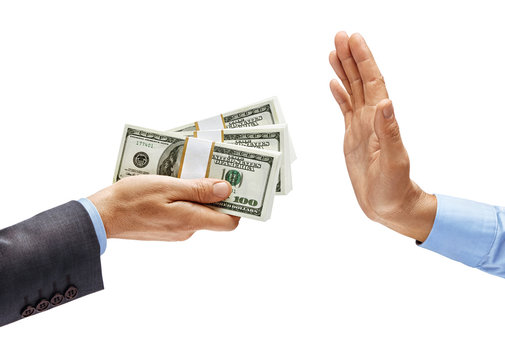Man's hand in suit giving bundles of money and man's hand in shirt showing stop sign isolated on white background. Business concept. Close up. High resolution product