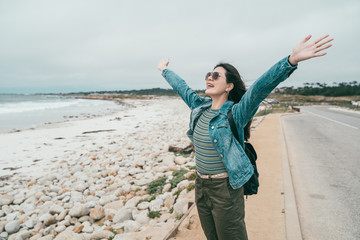 tourist raising hands over head and laughing