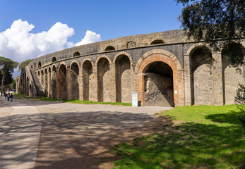 Fototapeta premium Pompeii, Naples/Italy - April 9, 2018: Pompeii Theater Entrance with blue cloudy sky