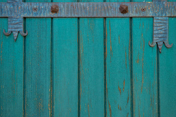 Green color old wooden doors with a forged metal