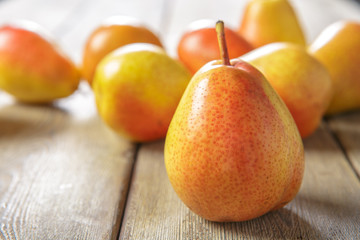 Ripe pears on rustic wooden table