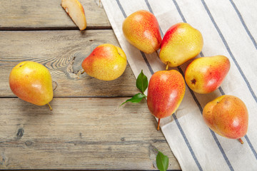 Ripe pears on rustic wooden table