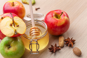 Jewish holiday Rosh Hashanah background with honey and apples on wooden table.