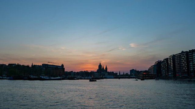 Sunset to night motion timelapse footage of the Church of Saint Nicholas and cityscape at Amsterdam, Netherlands