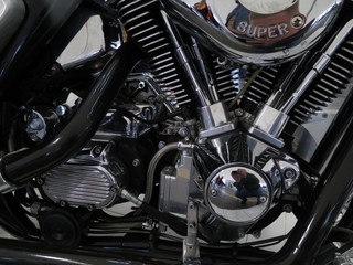 Chrome motorcycle engine parts close-up.  The engine and exhaust system in chrome of the motorcycle.