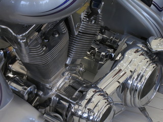 Chrome motorcycle engine parts close-up.  The engine and exhaust system in chrome of the motorcycle.