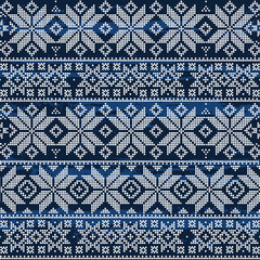 Abstract winter seamless pattern on a blue textured background. Geometric decor of white dots.