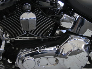 Chrome motorcycle engine parts close-up.  The engine and exhaust system in chrome of the motorcycle.