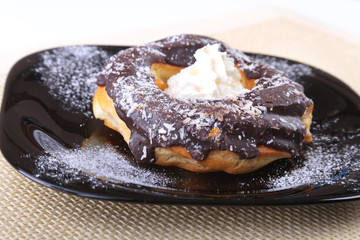 Homemade Traditional polish sweets doughnuts on black plate.