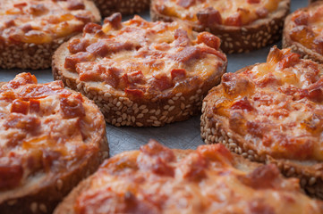 Quick Easy Snack. Sesame Bread Baked With Salami And Cheese On Oven Tray. Mini Pizza
