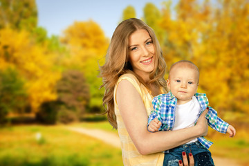 Fototapeta premium Mother hugging her child during walk in the park