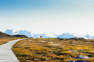 Tourists walking to the Ilulissat icefjord, Greenland © smallredgirl