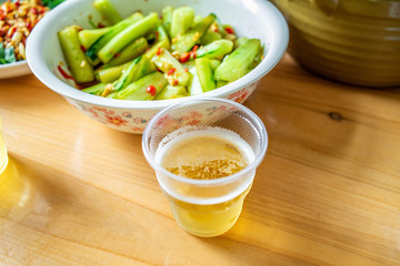 a glass of beer and vegetables on the dinner table