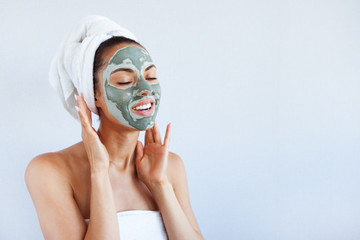 Young beautiful woman in face mask of therapeutic blue mud. Spa treatment, self care and healthy skin - 222926646