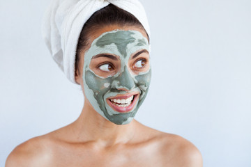 Young beautiful woman in face mask of therapeutic blue mud. Spa treatment, self care and healthy skin