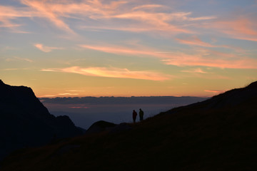 Young couple admiring the sunset in mountain. Ivan Vazov Hut, Rila Mountains, Bulgaria